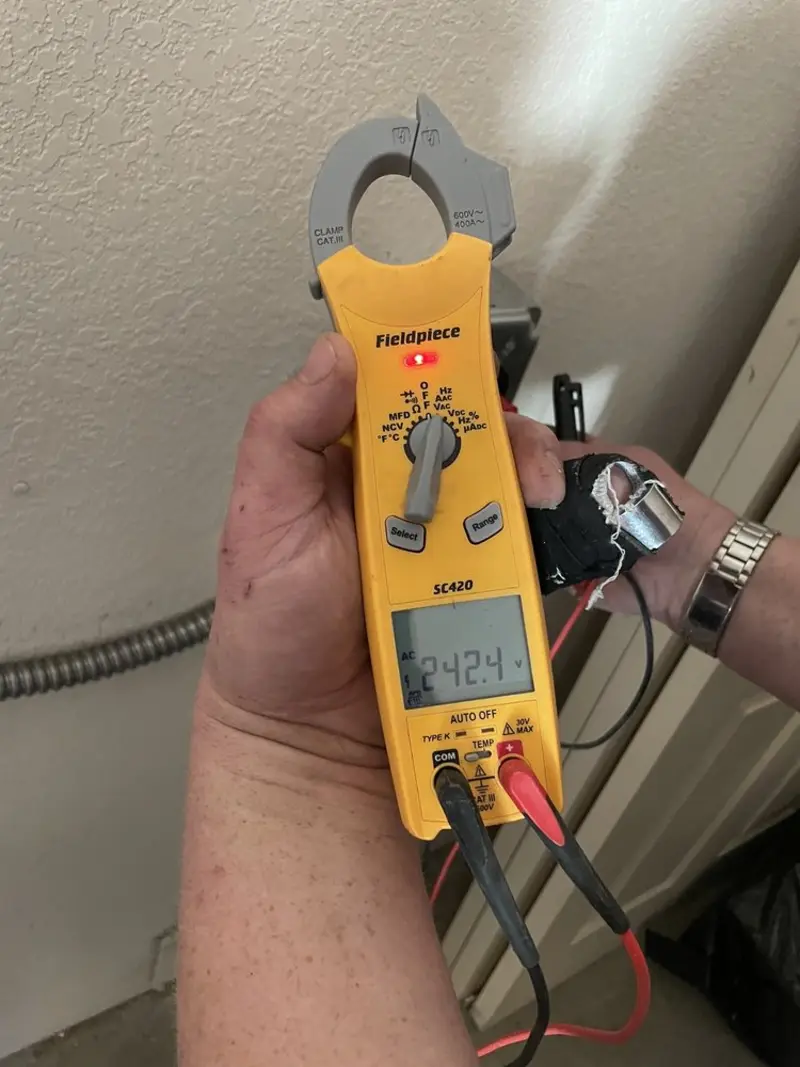 Voltage testing with clamp meter during Ceiling Fan Installation in Port Allen